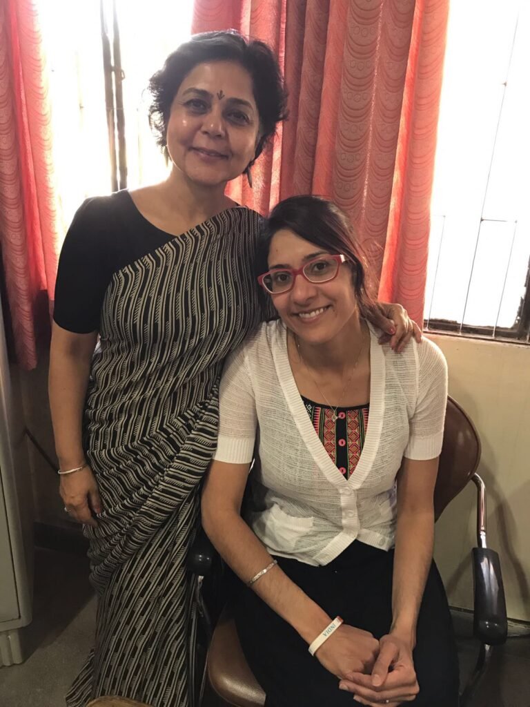 Dr. Sandhu sitting with a colleague during a consultation visit in Punjab